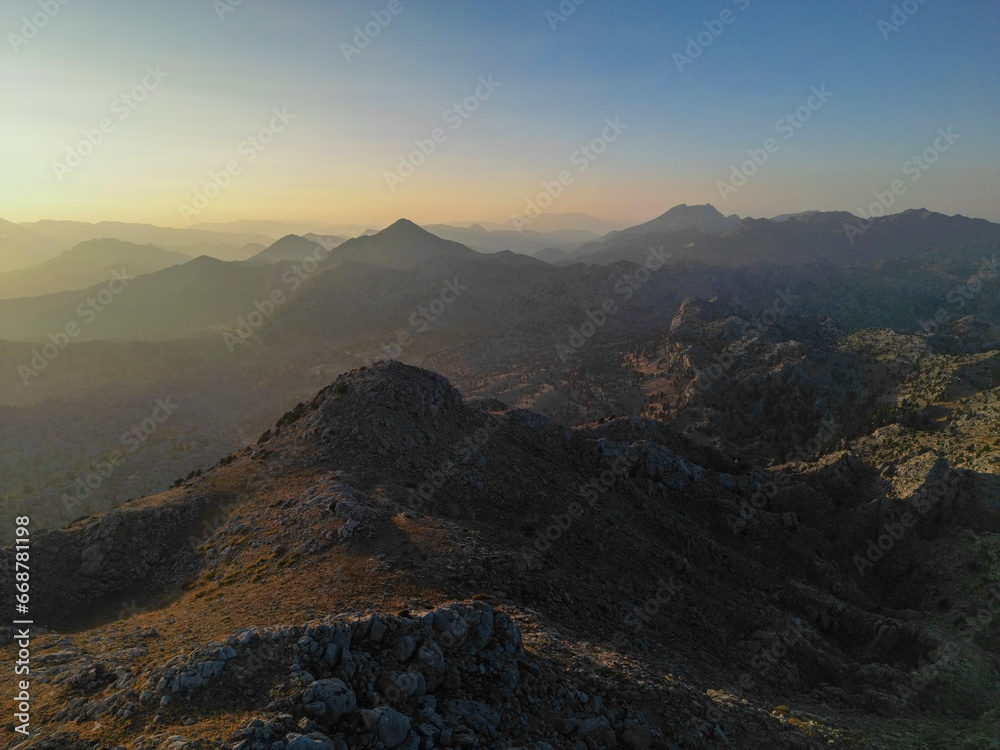 The mountain layers lined up one after the other and the wonderful and fascinating landscapes formed at sunset