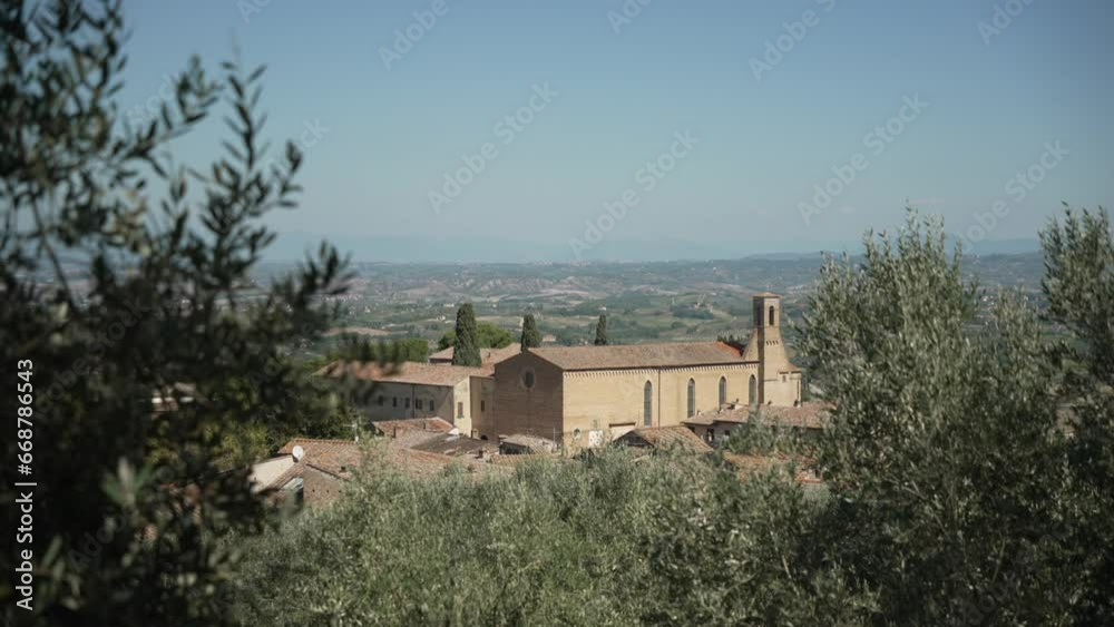 View of Chiesa di Sant Agostino church and rooftops in San Gimignano, San Gimignano, Province of Siena, Tuscany, Italy View of Chiesa di Sant Agostino church and rooftops in San Gimignano, San Gimignano, Province of Siena, Tuscany, Italy