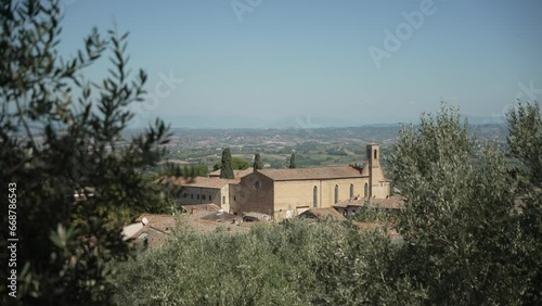 View of Chiesa di Sant Agostino church and rooftops in San Gimignano, San Gimignano, Province of Siena, Tuscany, Italy photo