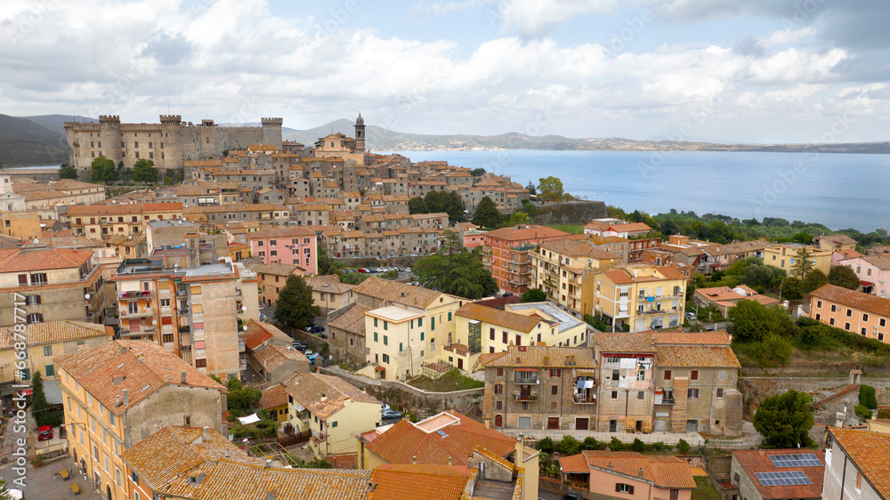 Aerial view of Bracciano, in the metropolitan city of Rome, Italy. The town is located on the shores of Lake Bracciano. In the historic center there is the castle and cathedral of Santo Stefano.