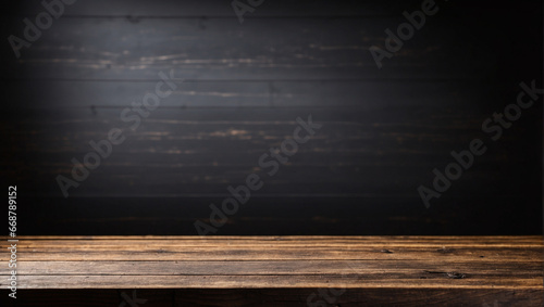 Empty wooden table in front with blurred black background