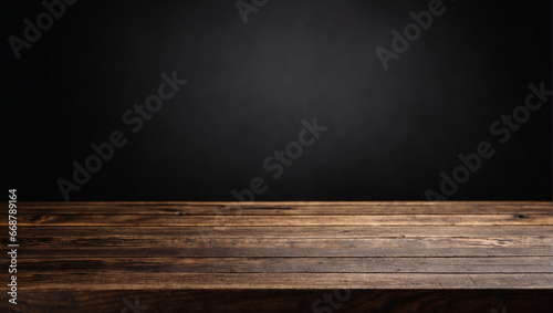 Empty wooden table in front with blurred black background