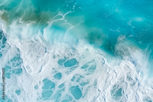 view of turquoise ocean water with splashes and foam for abstract natural background and texture