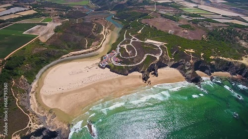 Aerial video filming by drone of the sea bay and beach near the village of Odeceixe Alentejo Portugal. Top view of the bay and village