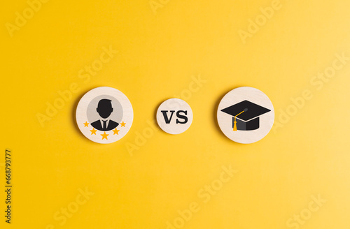 Knowledge vs Experience. Wooden label with Study vs Work icon options on yellow background. Job skill experience and building a career compared to Academic degree and formal education.