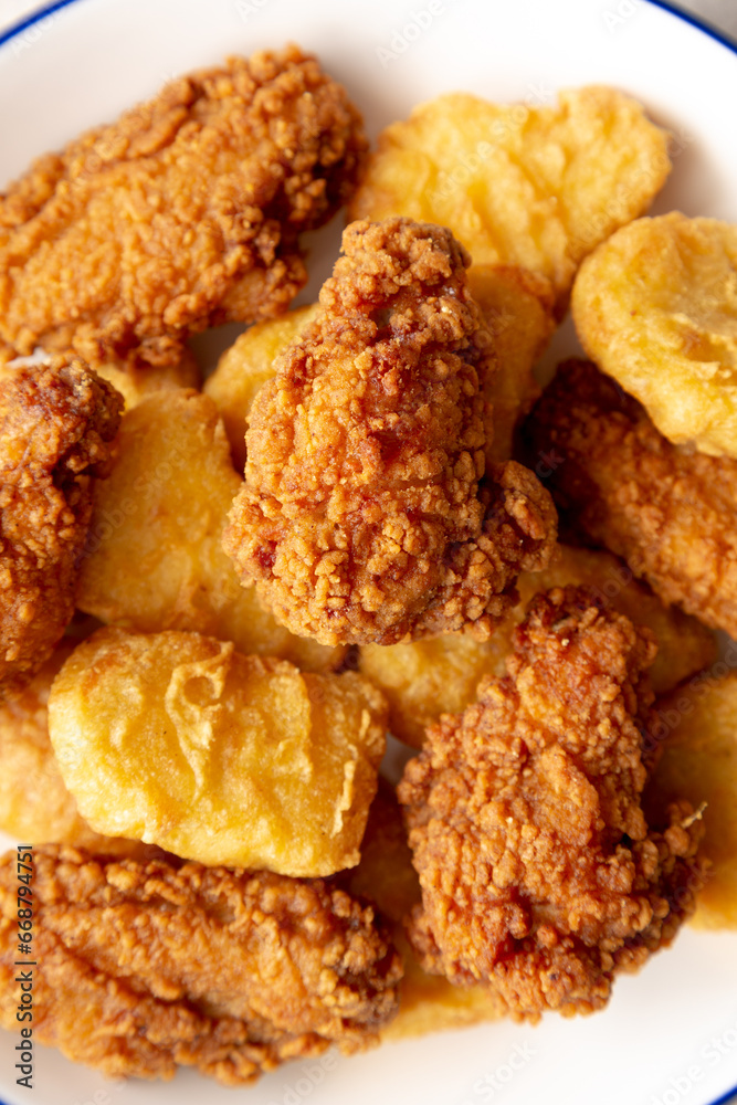 Homemade Chicken Nuggets and Chicken Wings with Ketchup, top view. Homemade Chicken Nuggets and Chicken Wings with Ketchup, top view.