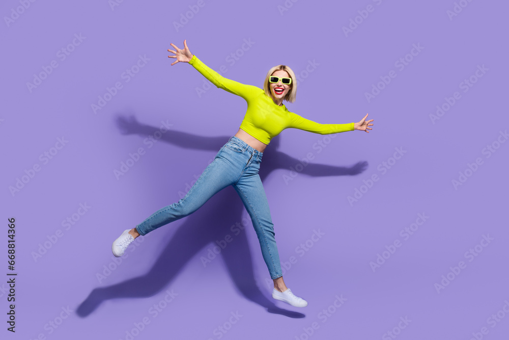 Obraz premium Full length photo of satisfied optimistic girl wear trendy clothes rejoice have fun walk empty space isolated on purple color background