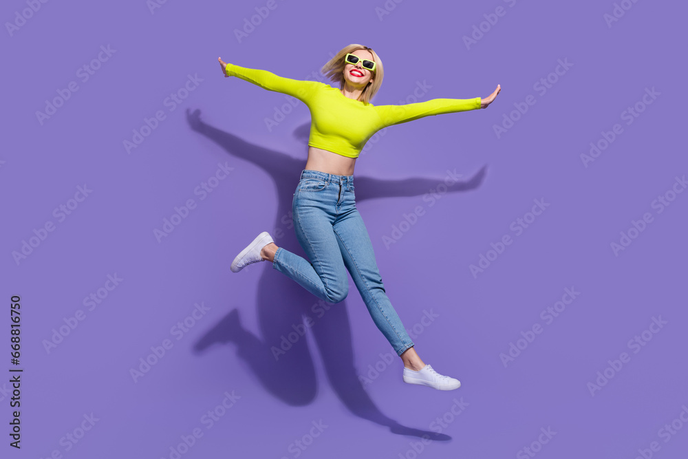 Full length photo of adorable cheerful girl wear trendy green lime clothes enjoying freedom isolated on purple color background