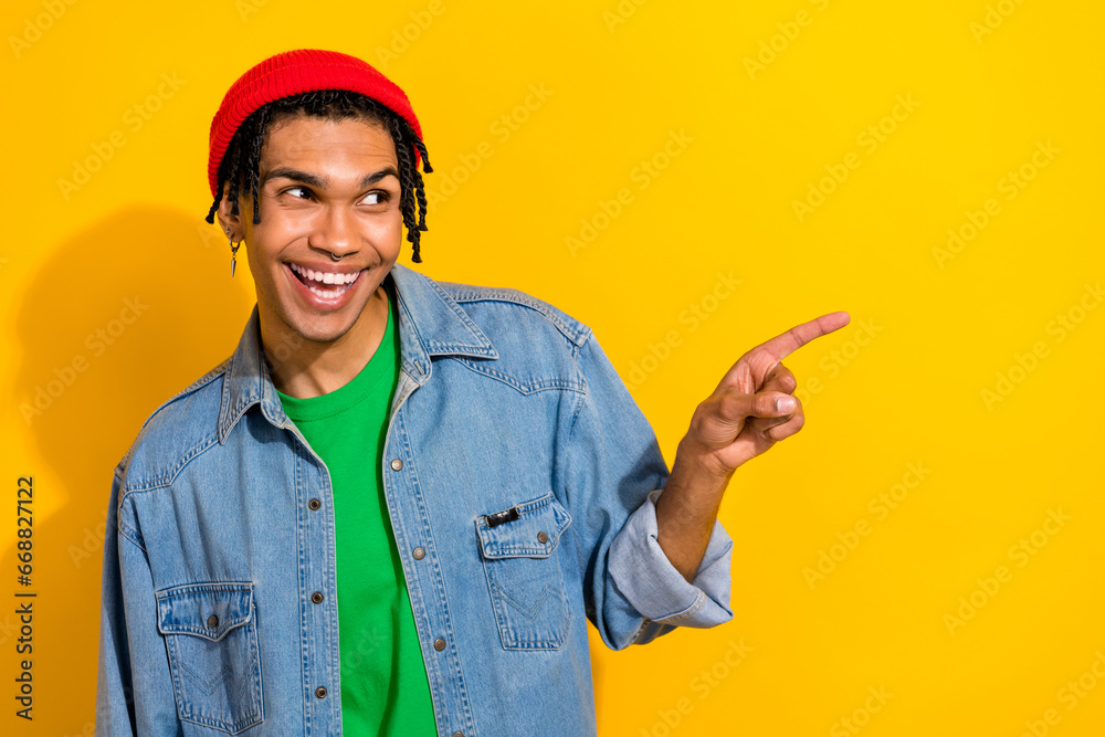 Photo of cheerful excited man wear jeans shirt red hat looking showing empty space isolated yellow color background Photo of cheerful excited man wear jeans shirt red hat looking showing empty space isolated yellow color background