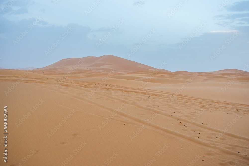 Sand dunes during sunset in Erg Chebbi desert, near Merzouga, Sahara Desert, in Morocco.