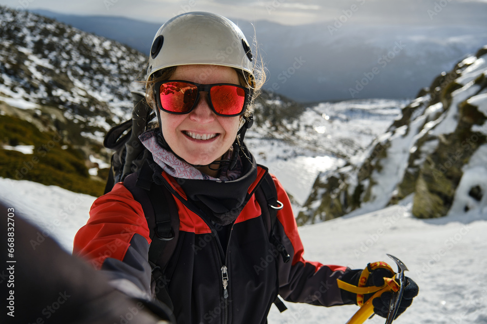 Mountaineer taking selfie on snowy terrain during hiking