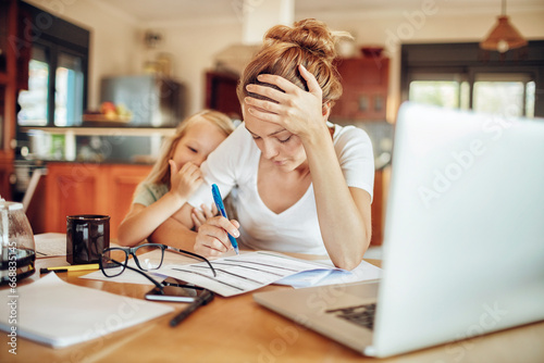 Photos Happy young girl comforting her mother during a financial crisis at home