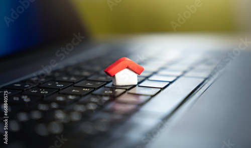 House on a computer keyboard. Paying bills online. House and utilities. Electricity, heating, water and gas. Energy efficiency. Electronic documentation in registers. Registration of property.
