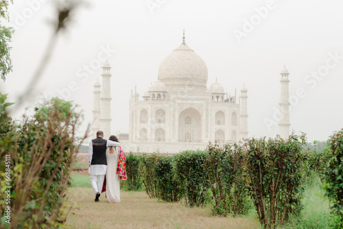 couple with the view of Taj Mahal in Agra, India