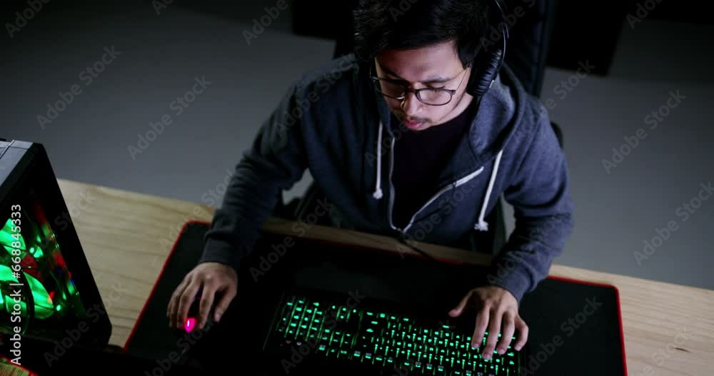 Computer, keyboard light and gaming man, nerd or video game tester check virtual graphic, software design or gameplay. Night gamer typing, playing or control esports, digital world or cyber challenge