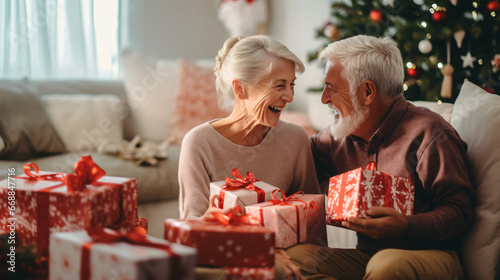 Senior Couple Exchanging Gifts As They Celebrate Christmas At Home With Family