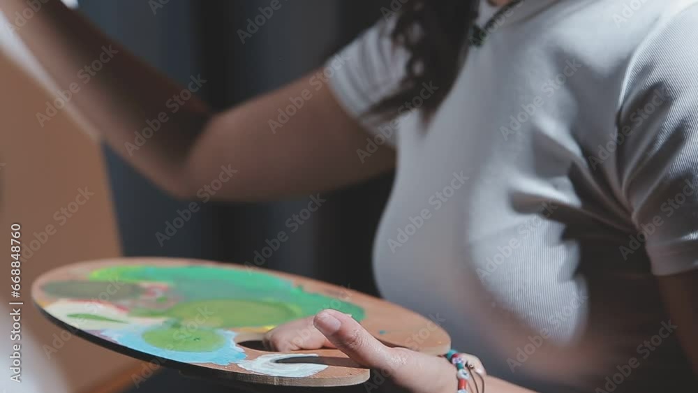 Attractive young woman attending a painting workshop, having fun, create an inspired art work at art studio Attractive young woman attending a painting workshop, having fun, create an inspired art work at art studio