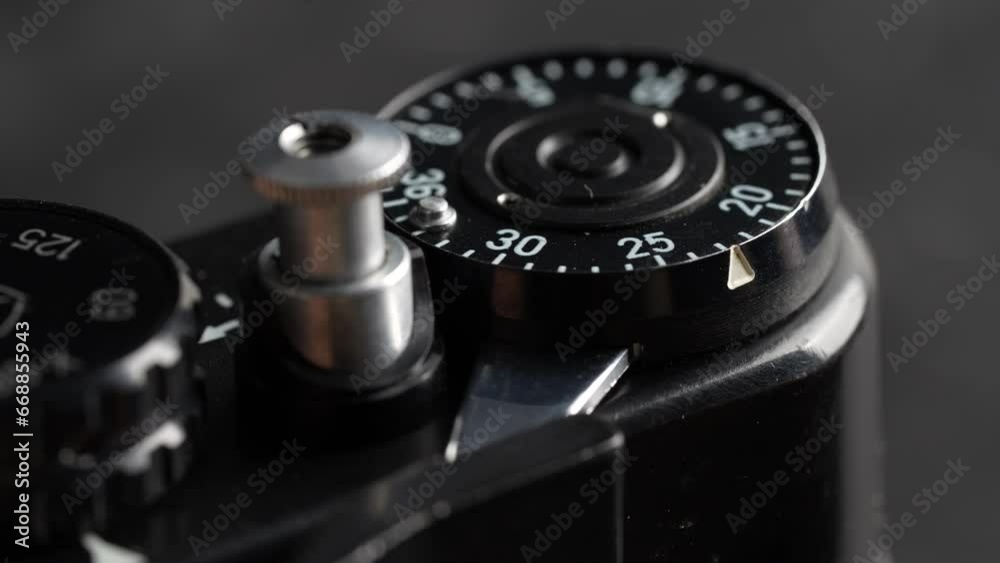 Settings mechanism on mirror analog film camera. Rotation, using mechanical wheel. Vintage photo camera, 35mm film, made in USSR, close up Settings mechanism on mirror analog film camera. Rotation, using mechanical wheel. Vintage photo camera, 35mm film, made in USSR, close up