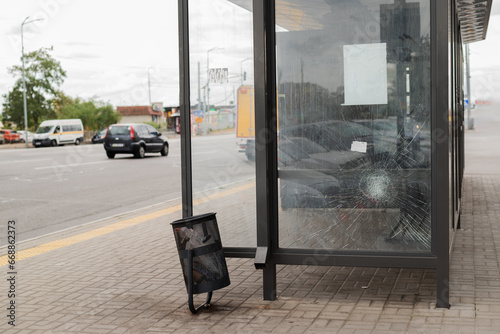 Broken glass at the bus stop. Public transport station vandalised by the glass windows. cracks of tempered glass