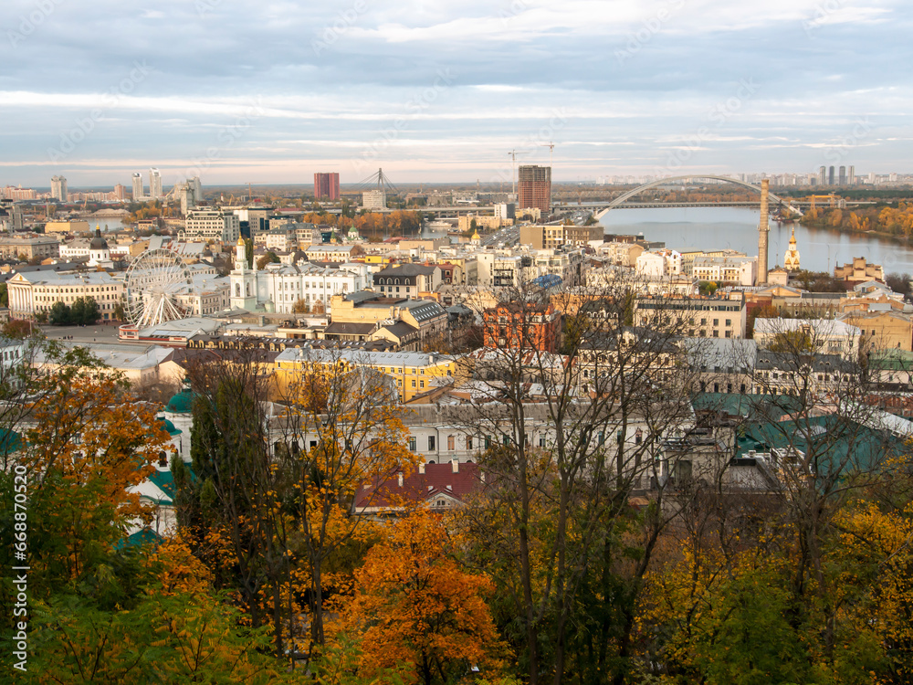 Downtown of Kyiv, Ukraine in autumn. Views of historic architecture and landscape, nature of Kyiv. Dnipro river and yellow trees in the city center.