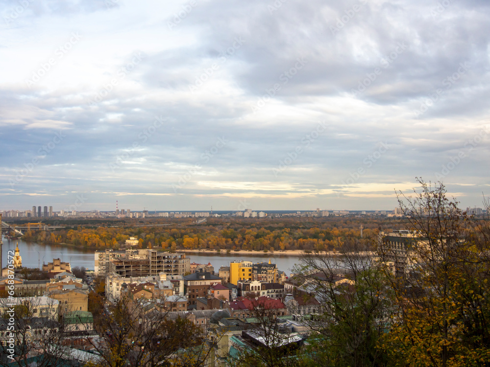 Downtown of Kyiv, Ukraine in autumn. Views of historic architecture and landscape, nature of Kyiv. Dnipro river and yellow trees in the city center.