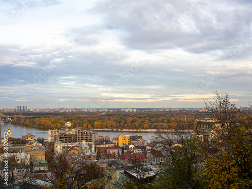 Downtown of Kyiv, Ukraine in autumn. Views of historic architecture and landscape, nature of Kyiv. Dnipro river and yellow trees in the city center. © Sergio