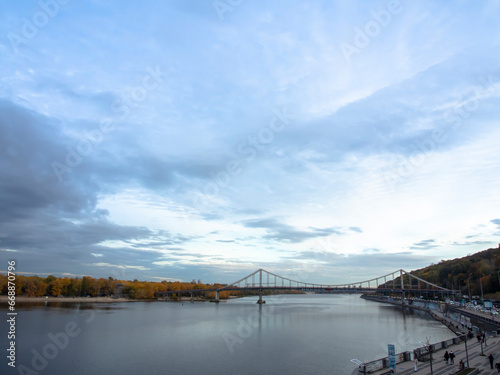 View of the Dnipro River and yellow trees in the center of the city. Historical architecture and landscape  nature of Kyiv. The city center of Kyiv  Ukraine in autumn. Beautiful sky.