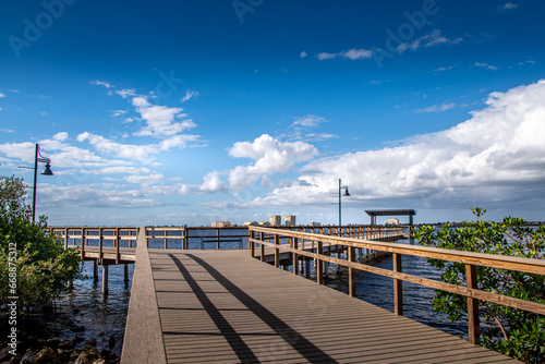 Scenes along Bradenton Florida Riverwalk East, boardwalk, wooden pier, structures, park and nature scenes, wooden observation tower, Manatee River. Blue skies white full clouds. Florida nature scene