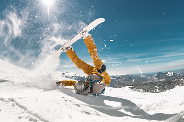 Real snowboarder falls at offpiste ski slope. ski safety concept