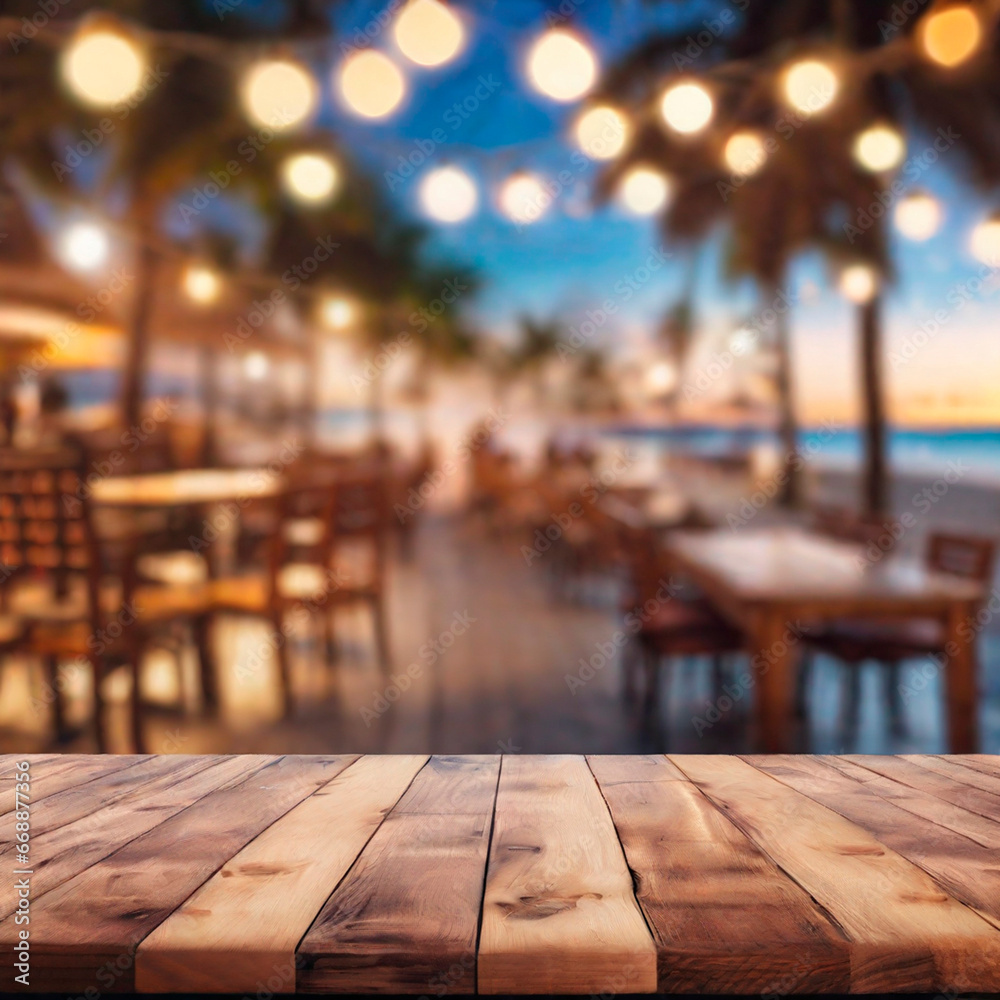 Empty wooden table and abstract blurred background of cafe with bokeh light. Wooden table with blur beach cafes background and bokeh lights created.  - obrazy, fototapety, plakaty 
