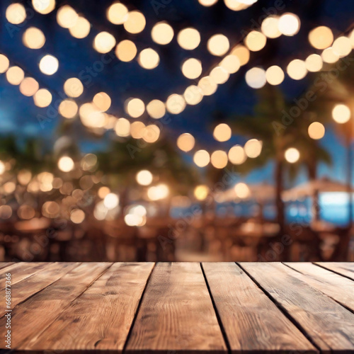 Empty wooden table and abstract blurred background of cafe with bokeh light. Wooden table with blur beach cafes background and bokeh lights created. 