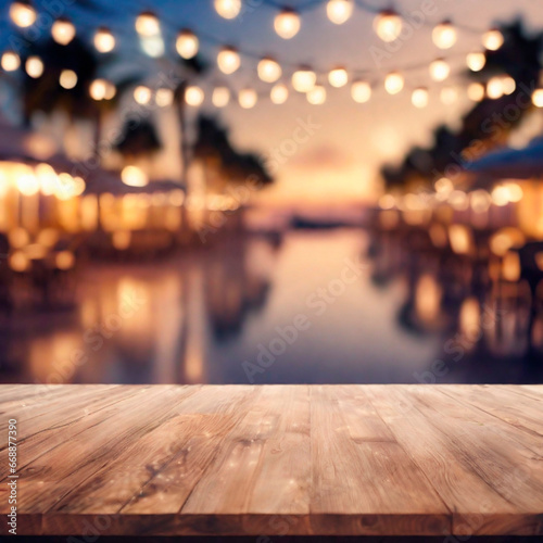 Empty wooden table and abstract blurred background of cafe with bokeh light. Wooden table with blur beach cafes background and bokeh lights created. 
