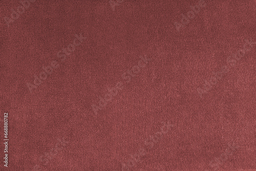 Texture background of velours red fabric. Upholstery texture fabric, velvet furniture textile material, design interior, decor. Fleecy fabric texture close up, backdrop, wallpaper.