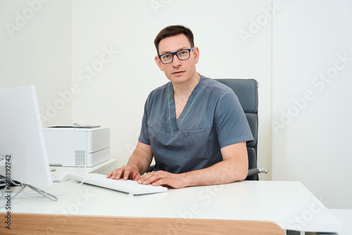 Doctor works at a computer in the workplace