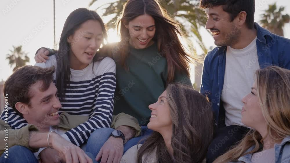 Group of diverse friends happy enjoying sunny day together outdoors in park. Young multiracial nice people gathered hugging talking happy. Millennial sitting in community laughing on weekend getaway. Group of diverse friends happy enjoying sunny day together outdoors in park. Young multiracial nice people gathered hugging talking happy. Millennial sitting in community laughing on weekend getaway.