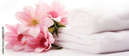 Isolated spa setup with towels and flowers on white background