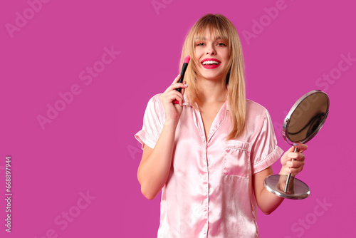 Young woman in pajamas with...