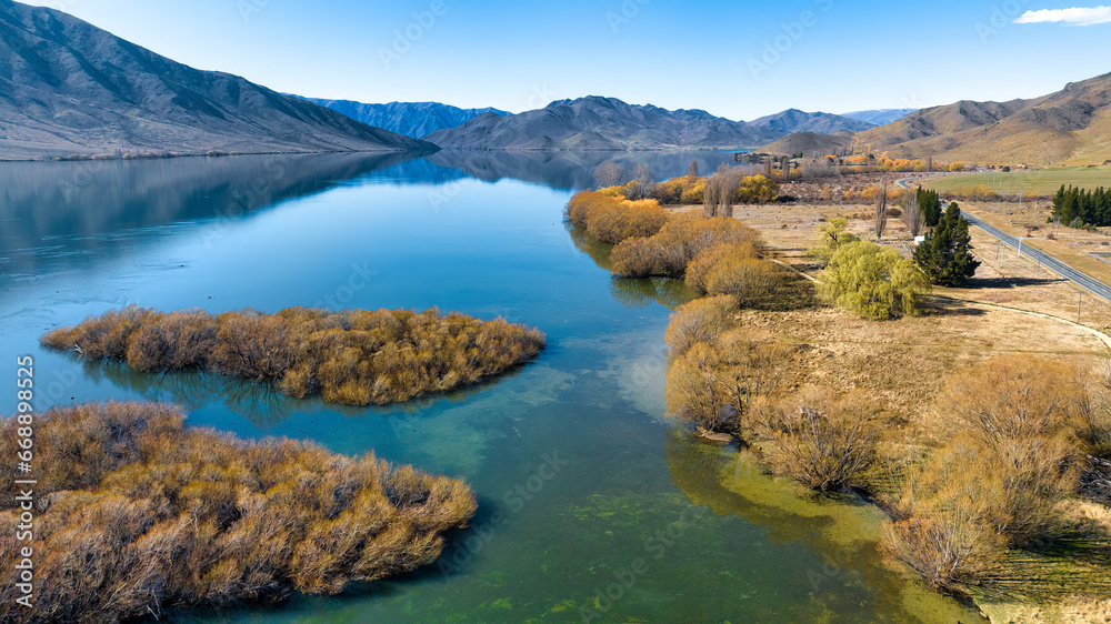 Aerial drone point of view of the mountain ranges and lakeshore of Lake Benmore Aerial drone point of view of the mountain ranges and lakeshore of Lake Benmore