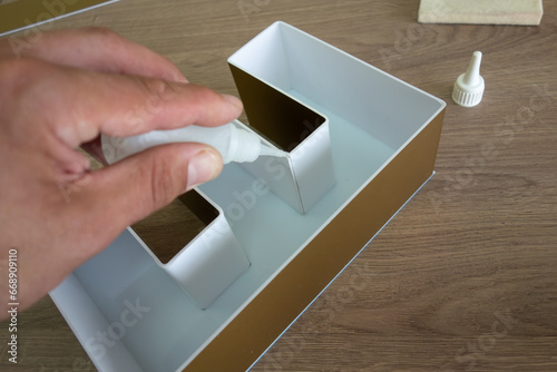 Canvas Print Gluing a logo made of PVC plastic in production