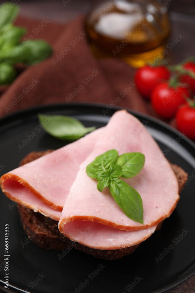Delicious sandwich with ham on plate, closeup