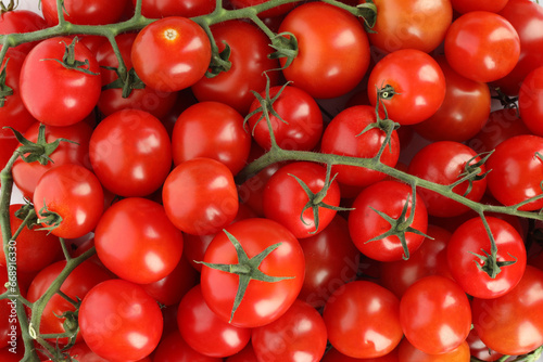 Many fresh ripe cherry tomatoes as background, top view
