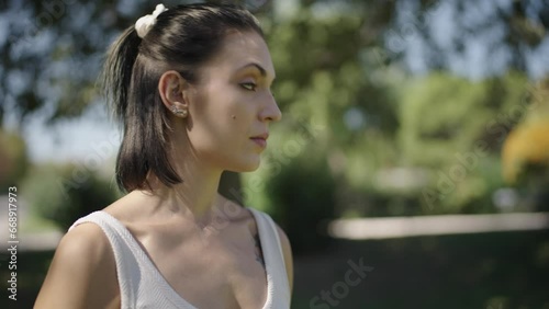 young Spanish woman exercising her body with elastic bands in a park in her city