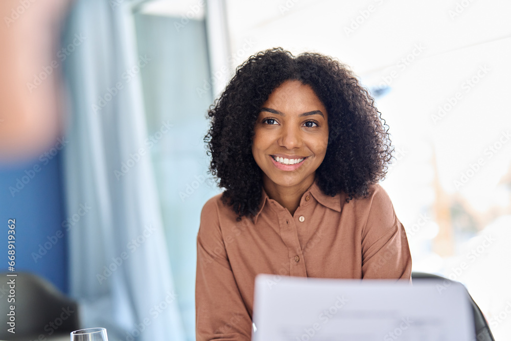 Young happy African American business woman worker or student, hr manager sitting at meeting listening attentively at work office meeting, education training class or job interview. - obrazy, fototapety, plakaty 