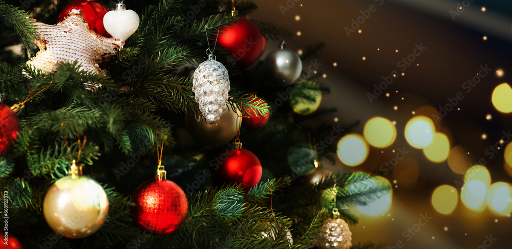 Beautifully decorated Christmas tree against blurred lights, bokeh effect. Banner design