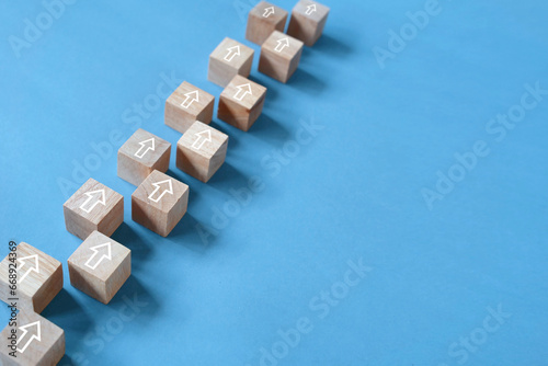 Step by step keep forward concept, arrow direction, wooden block on blue