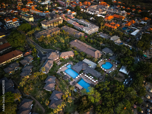 Aerial view of luxury hotel or resort buildings at beach with swimming pools. Concept for tourism, tourist destination, vacation, tropical villa, island life.