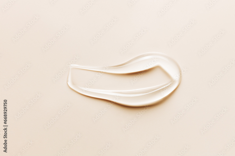 Gel beauty serum swatch smear on light beige background. Clear skincare product close-up Gel beauty serum swatch smear on light beige background. Clear skincare product close-up