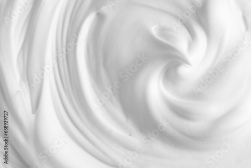 Thick foam swirl texture. White cream, mousse, cleanser, shampoo, shaving foam. Foamy cosmetic product closeup