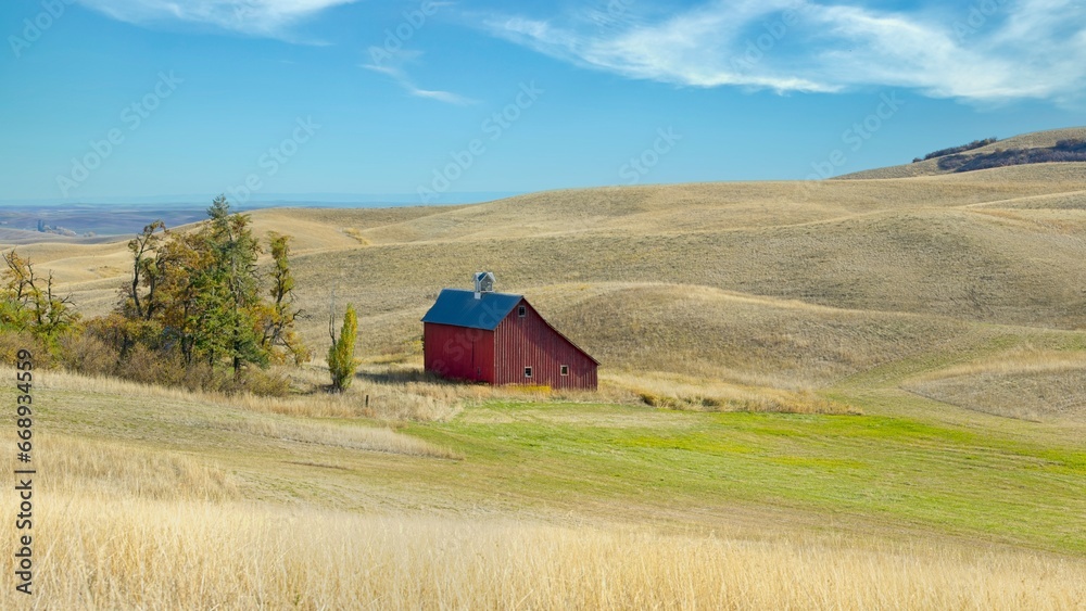 Panorama of red barn in a field in Idaho.