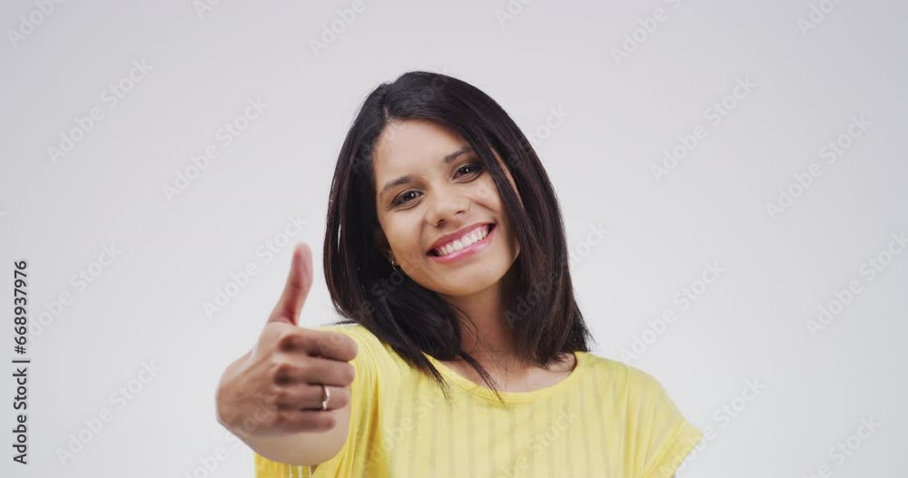 Face, smile and woman with thumbs up for agreement in studio isolated on a white background. Portrait, like hand sign and success of happy person, feedback and winner vote to recommend mockup space Face, smile and woman with thumbs up for agreement in studio isolated on a white background. Portrait, like hand sign and success of happy person, feedback and winner vote to recommend mockup space